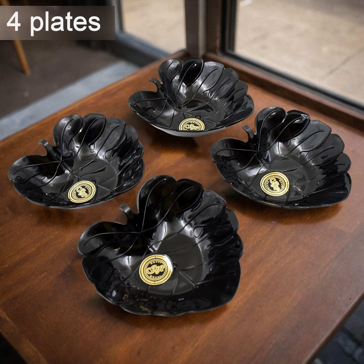 Ceramic tea cup and bowl set displayed on a wooden table with elegant flower-shaped black plates
