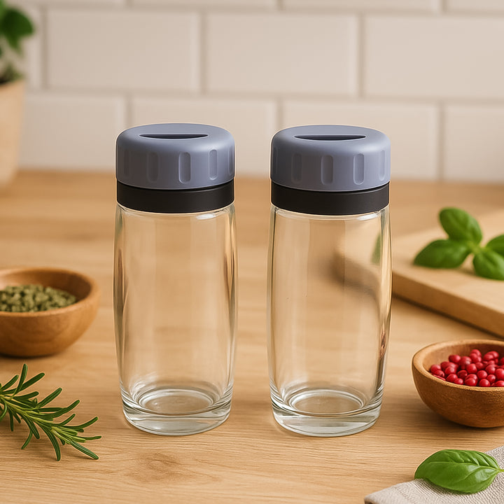 Apex acrylic salt and pepper shakers with gray lids on wooden kitchen countertop