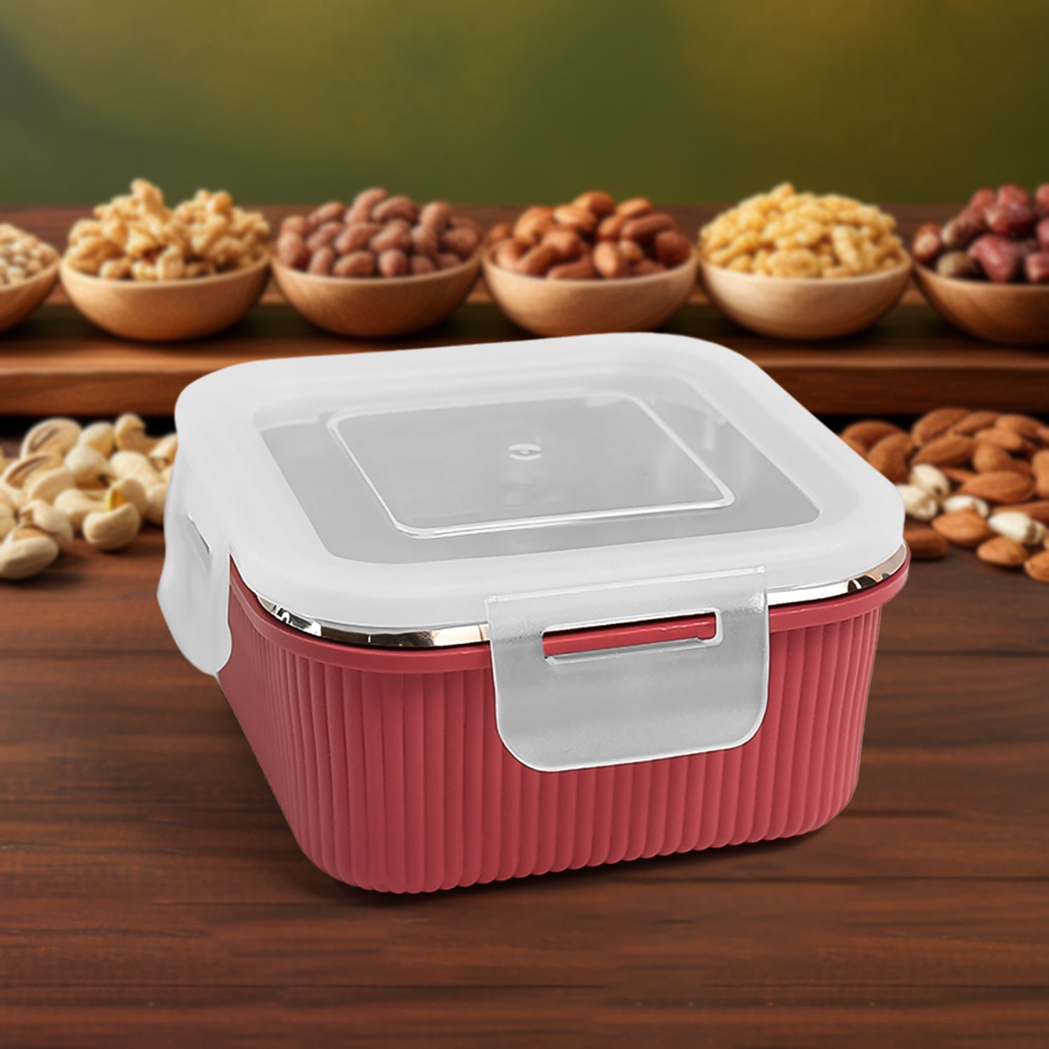 Apex Victor food container in red with white lid and secure clasp on wooden surface with nuts background