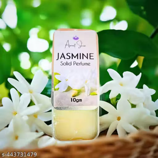 Jasmine solid perfume in a 10gm container surrounded by fresh jasmine blossoms