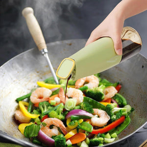 Hand pouring oil from an automatic oil dispenser for kitchen over colorful vegetables and shrimp in a pan