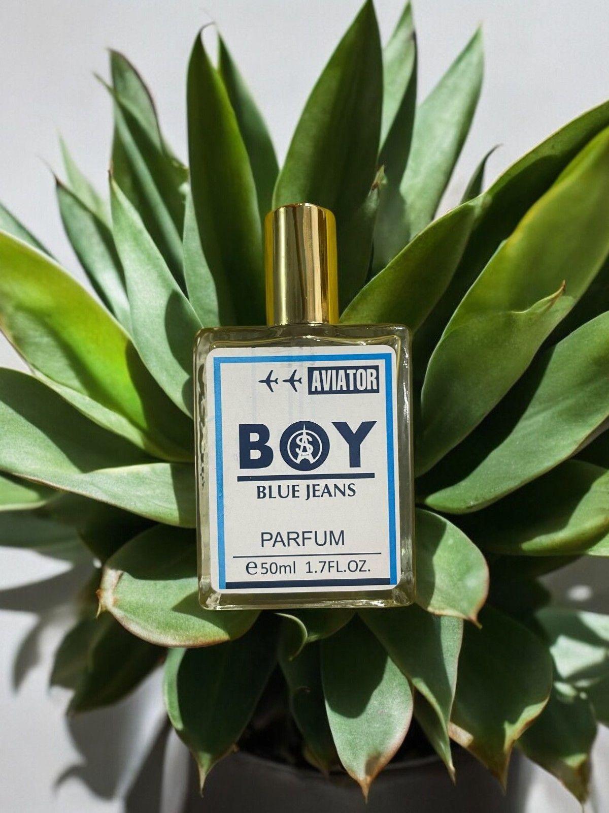 Aviator BOY Blue Jeans Fragrance 50ml bottle placed among green plants for a fresh look