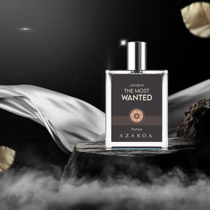 Azaroa The Most Wanted Perfumes bottle on wooden display with dramatic background and flowing silk