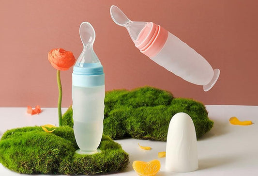 Two Superior eMart baby food feeder spoons in pink and blue, ideal for easy baby feeding