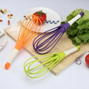 Set of colorful silicone balloon whisk mixers for kitchen in orange, purple, and green for easy mixing