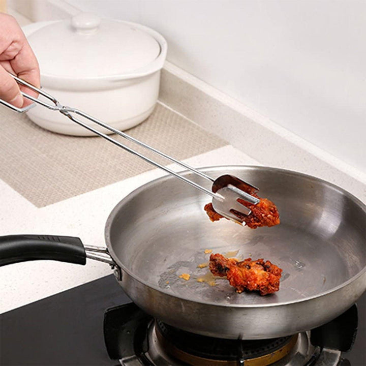 Superior eMart multi functional BBQ tongs used to lift fried food from a pan in the kitchen