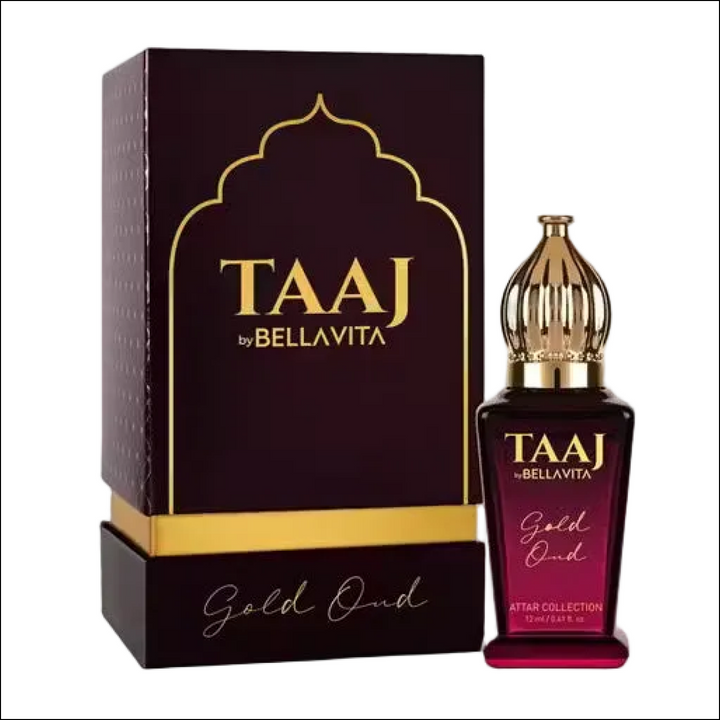 TAAJ by BELLAVITA Gold Oud Attar: Maroon glass bottle with ornate gold cap and matching gold-accented luxury box.