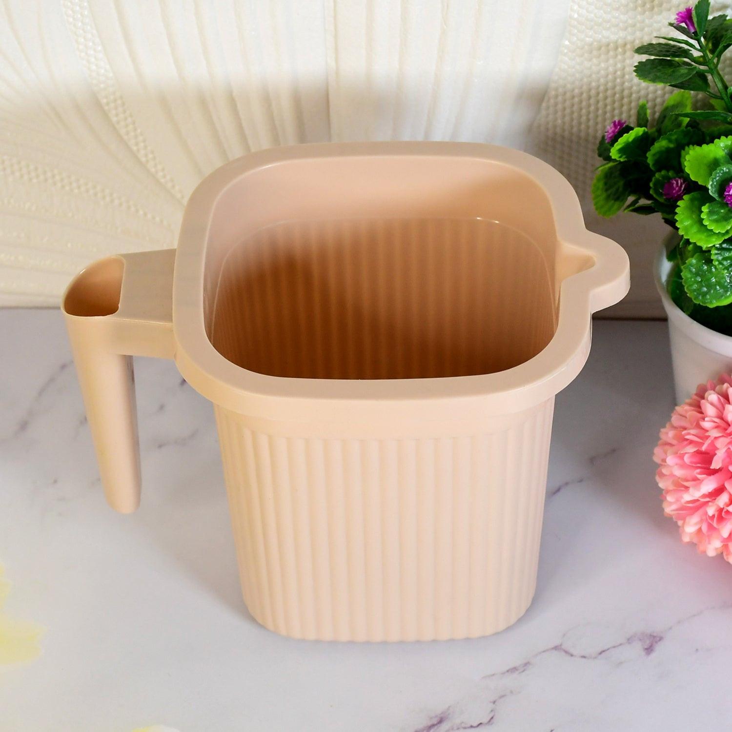 BPA free bath mug in soft peach color with ribbed design and comfortable handle for easy use