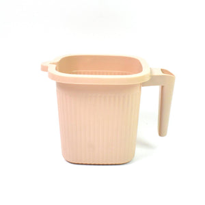 BPA free bath mug in soft pink color with a sturdy handle for easy use in the bathroom