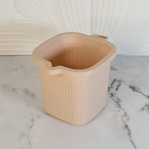 BPA free bath mug in soft pink color with ribbed texture and convenient handle