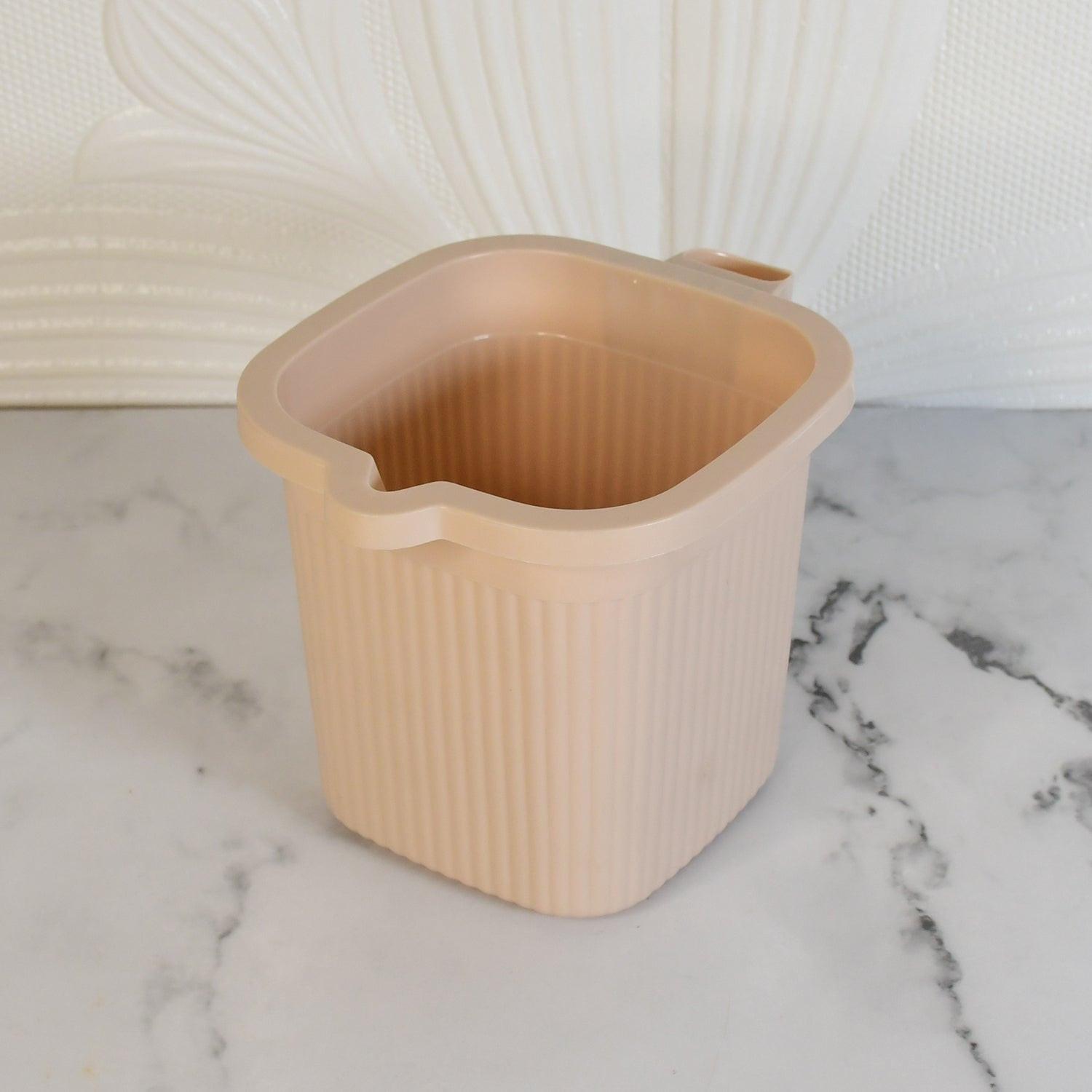 BPA free bath mug in soft pink color with ribbed texture and convenient handle