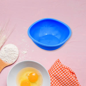 Bright blue BPA free bowl set with a white mixing bowl and eggs on a kitchen countertop
