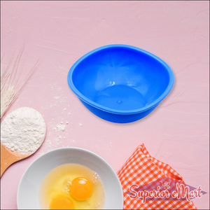 Bright blue BPA free bowl set with a white mixing bowl and eggs on a kitchen countertop