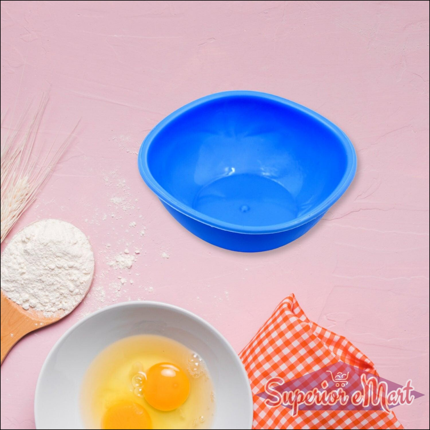 Bright blue BPA free bowl set with a white mixing bowl and eggs on a kitchen countertop