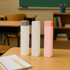 Superior eMart BPA-free hydration water bottles in gray white and pink on desk with notebook
