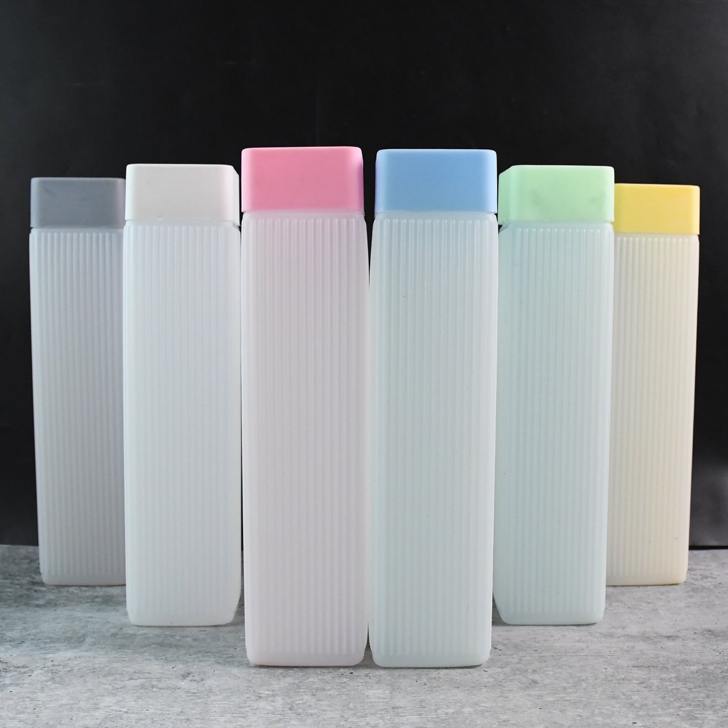 Set of six BPA-free hydration water bottles with colorful caps in white ribbed design for home and kitchen use