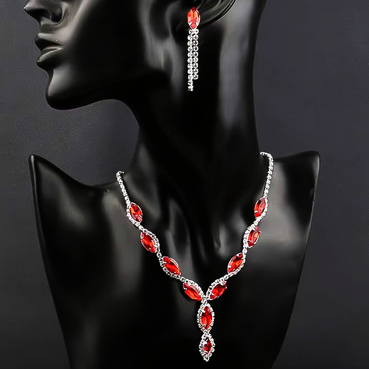 Stunning bridal necklace and earrings set with red stones and crystal accents for elegant occasions