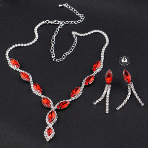 Elegant bridal necklace and earrings set featuring red gemstones and sparkling accents