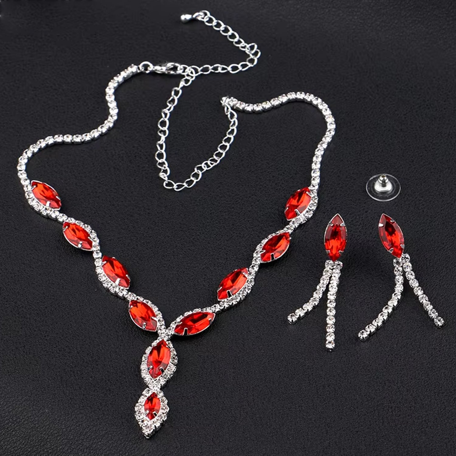 Elegant bridal necklace and earrings set featuring red gemstones and sparkling accents