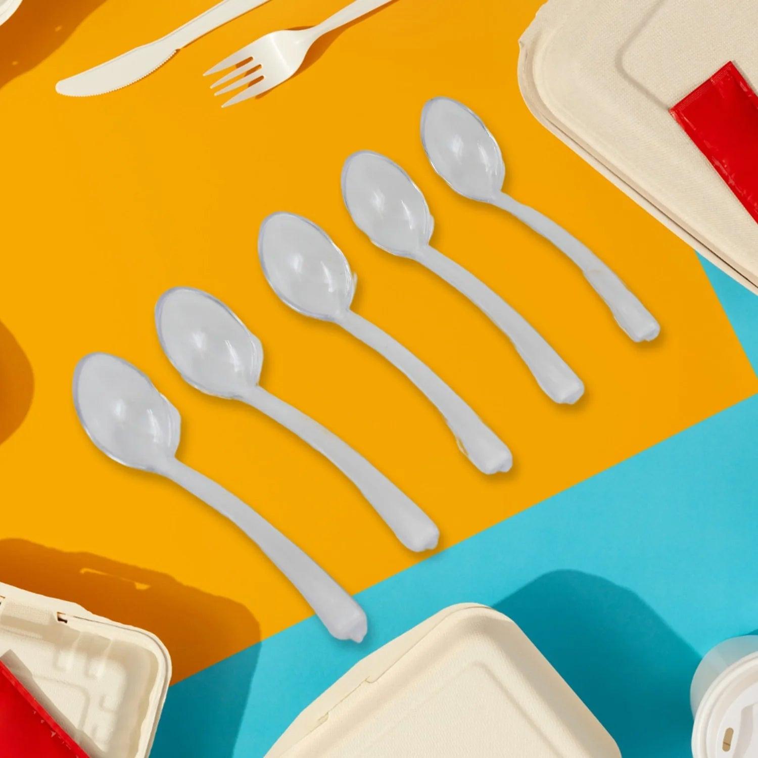 Durable plastic spoons in various sizes on a colorful background for dining and kitchen use