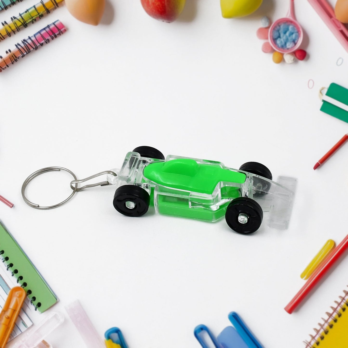 Colorful car shaped keychain in green and clear with wheels, ideal for kids and fun accessories