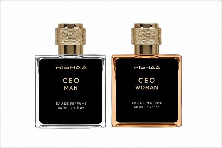 Two Rishaa perfume bottles, one for man and one for woman, with a couple in the background.