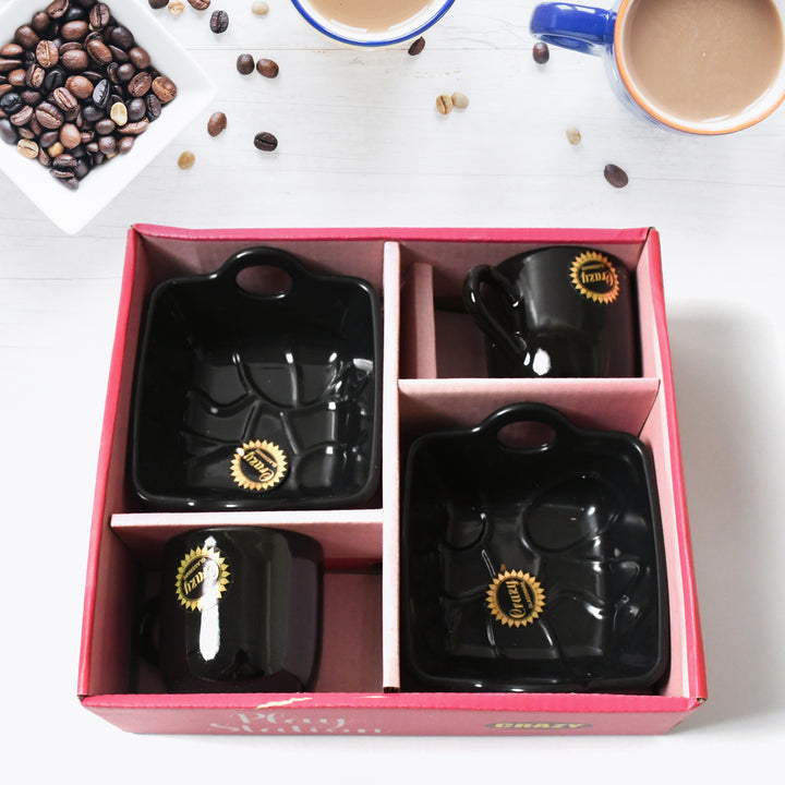 Ceramic tea cup mug set in elegant black design with matching square trays for stylish tea service