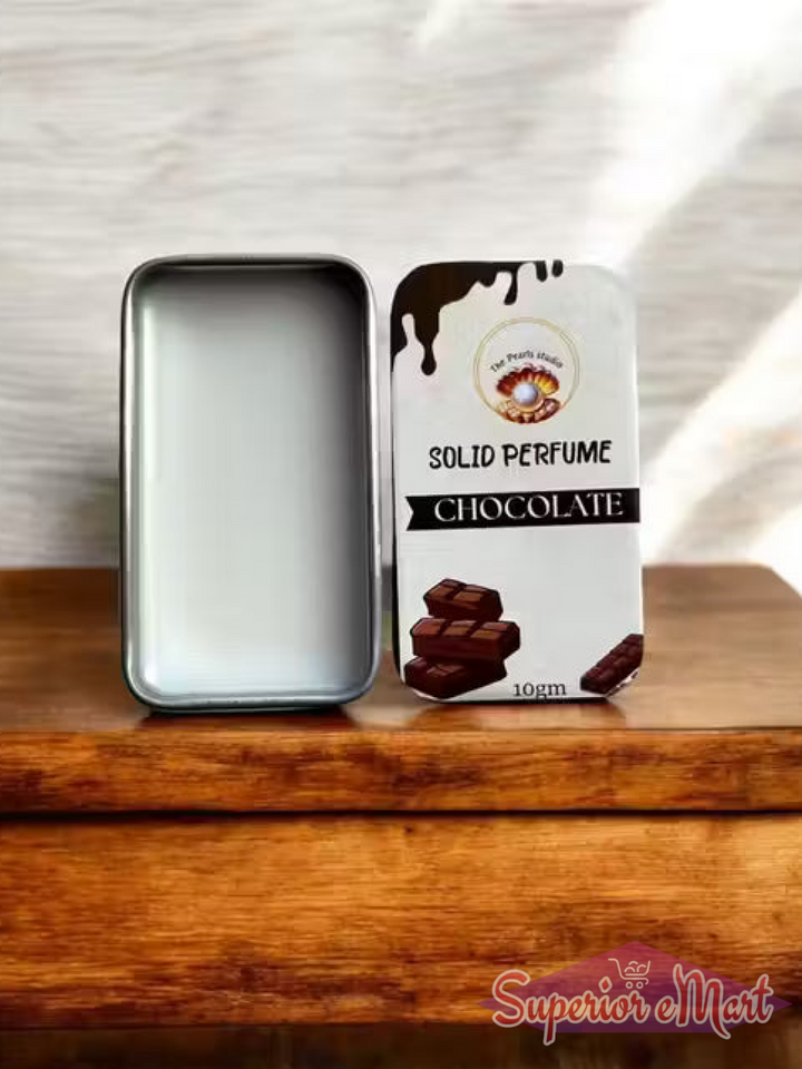 Silver tin of Chocolate Solid Perfume by The Pearl Studio. Open to show white wax; lid features chocolate graphics.