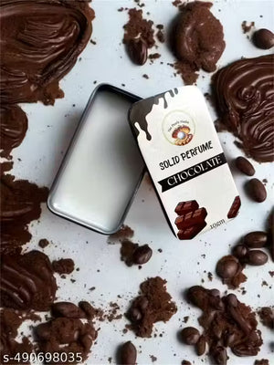 Chocolate solid perfume balm in a silver tin surrounded by cocoa and chocolate pieces