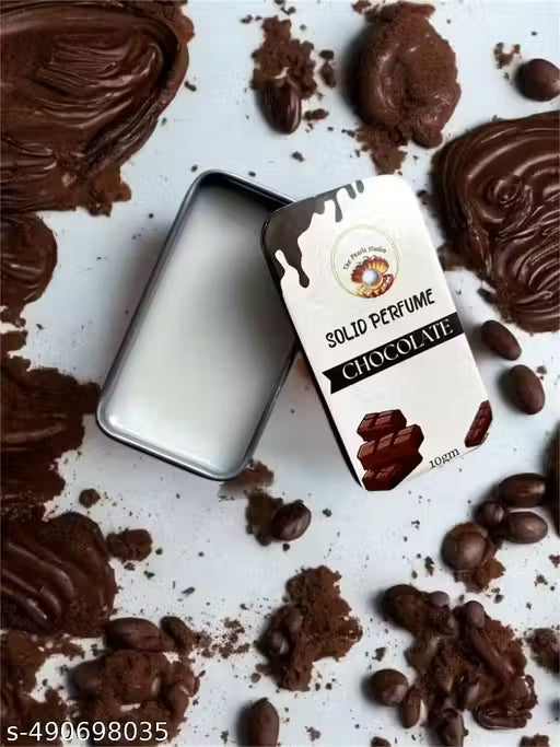 Chocolate solid perfume balm in a silver tin surrounded by cocoa and chocolate pieces