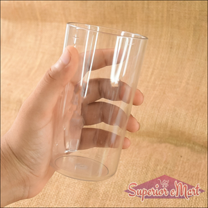 Person holding a clear unbreakable glass set in hand, ideal for family gatherings and outdoor use