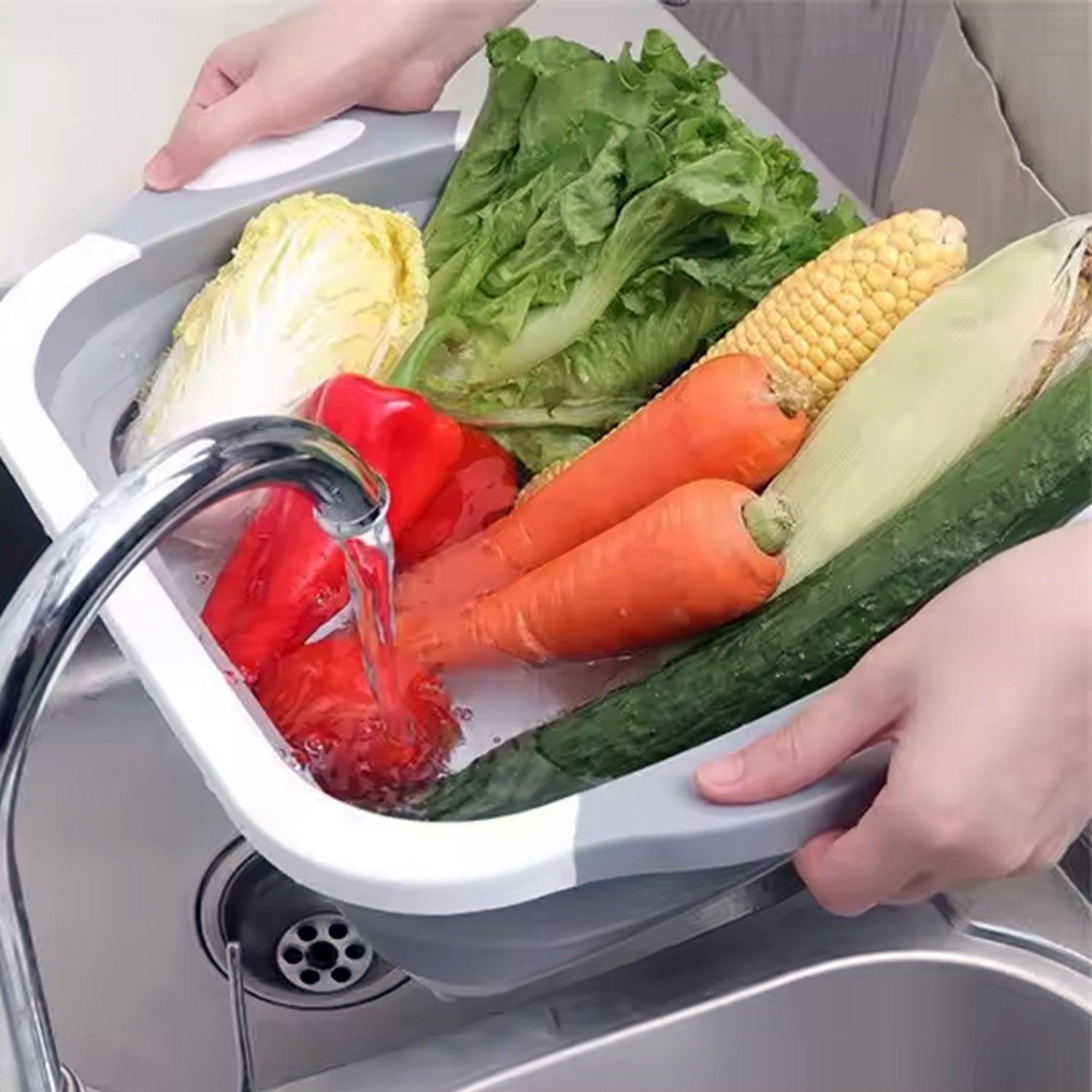 Collapsible cutting board with dish tub loaded with fresh vegetables for easy food preparation
