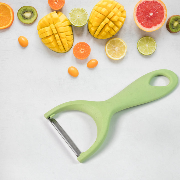 Colorful kitchen knives set 6 pcs with various fruits cut and displayed on a light surface