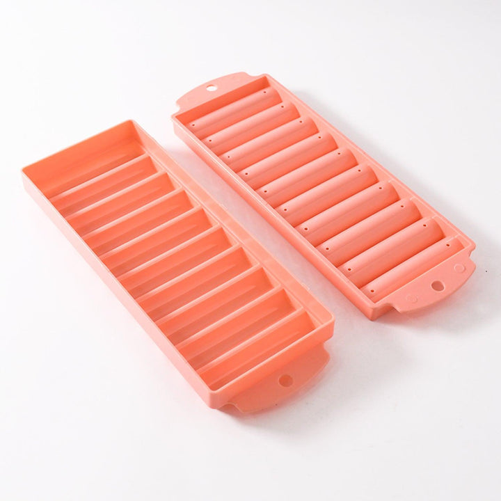 Pink compact ice stick tray with two separate molds for making long ice sticks