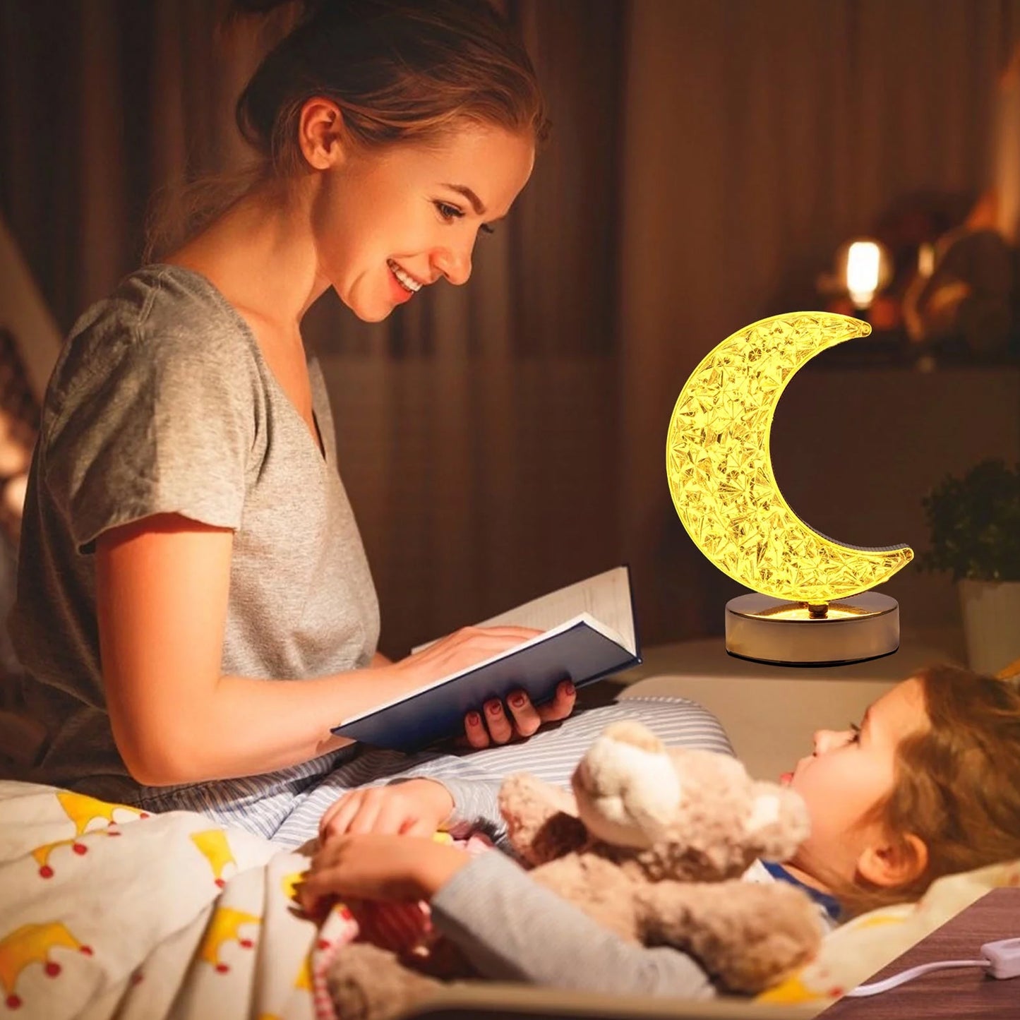Crystal moon table lamp illuminating a cozy room while a woman reads to a child