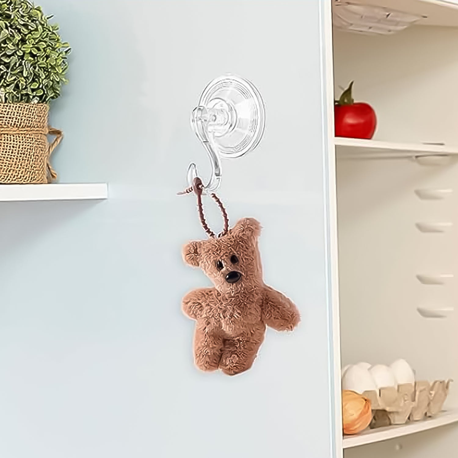 Clear cup hooks set of 10 displayed on a wall holding a small teddy bear for versatile storage
