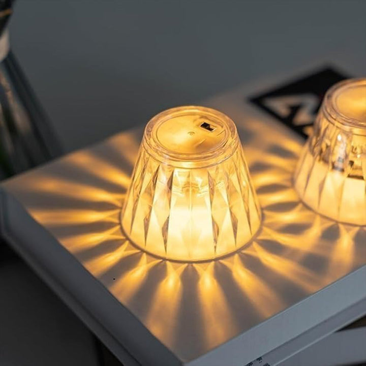 Cup shape crystal lamp with warm glow casting beautiful patterns on the surface