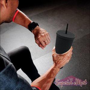 Matte studded tumbler with straw held by a person during a workout session for hydration
