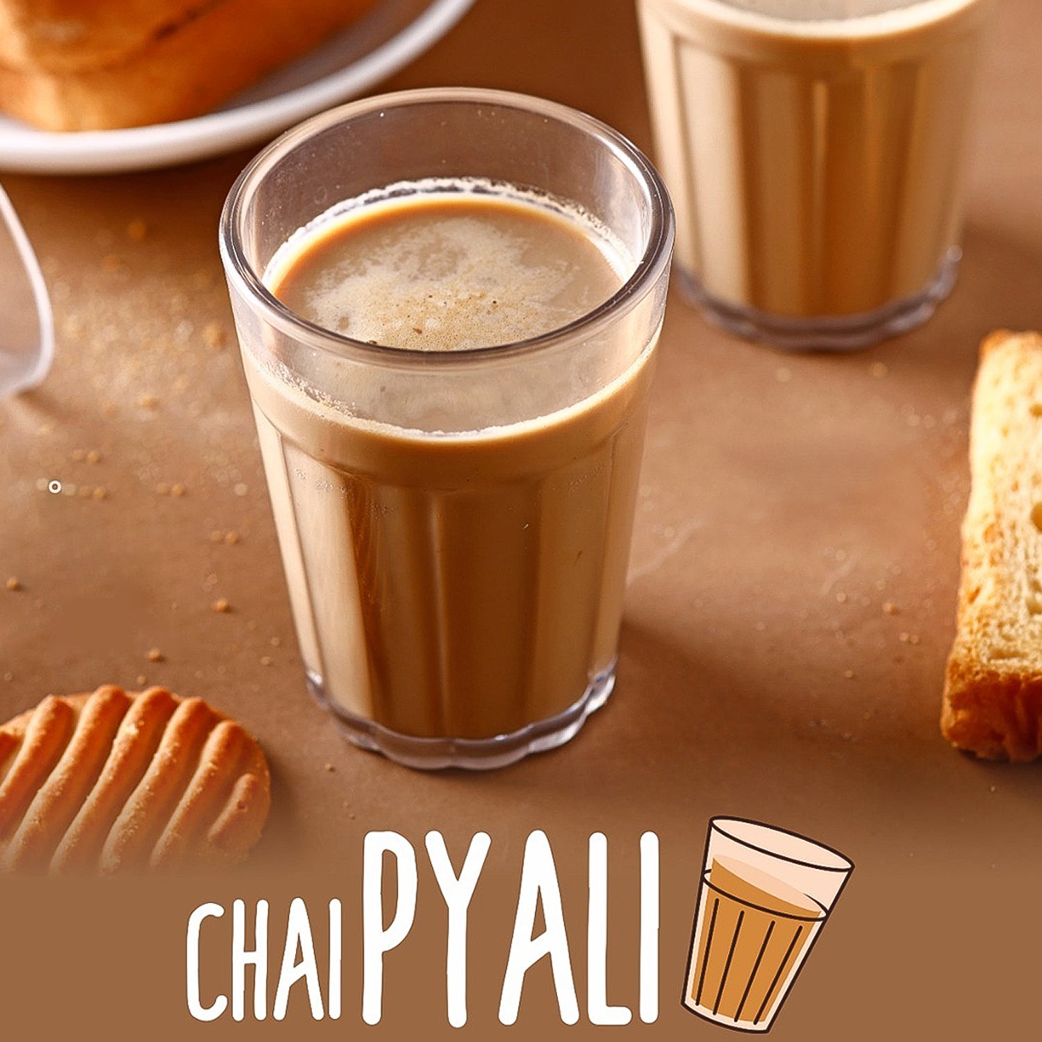 Superior eMart cutting chai glass set featuring clear glasses with chai and biscuits on a table