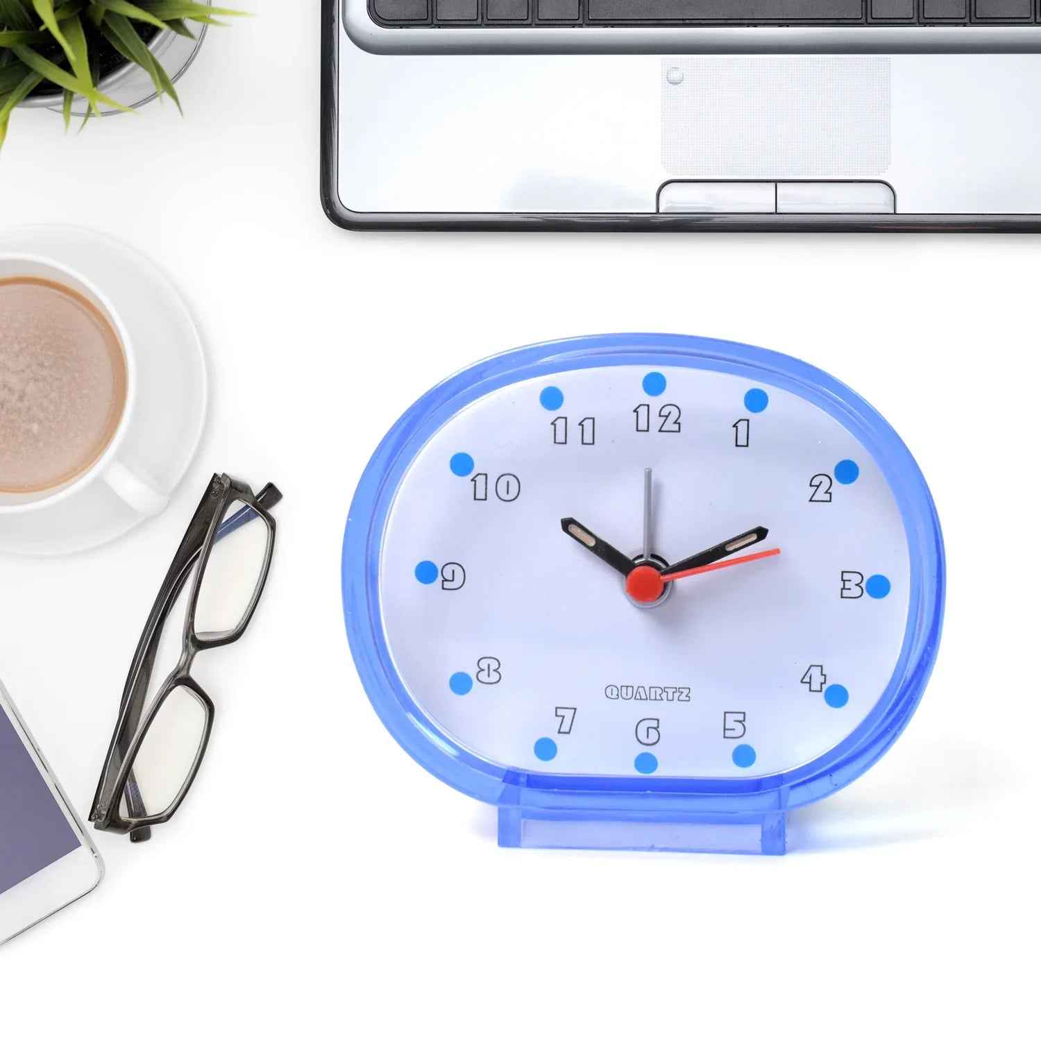Blue decorative clock on desk with coffee and glasses, ideal decorative clocks for every room
