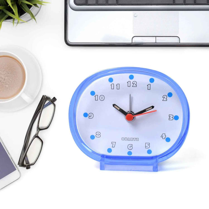 Blue decorative clock on desk with coffee and glasses, ideal decorative clocks for every room