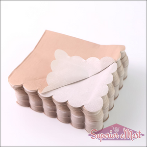 Scalloped edge disposable napkins in beige and white stack for elegant table settings