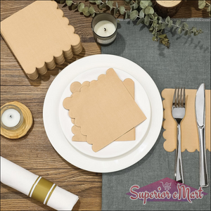 Scalloped edge disposable napkins packaged neatly on a dining table setting with tableware