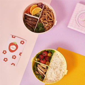 Colorful donut shaped lunch box divided for healthy meal storage with fruits and vegetables