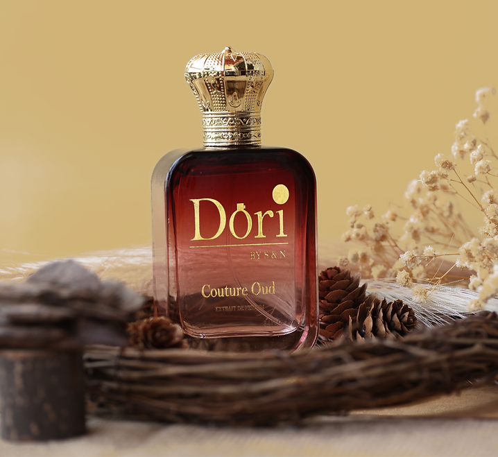 Couture Oud Unisex Perfume in an elegant bottle with a decorative cap, surrounded by natural elements