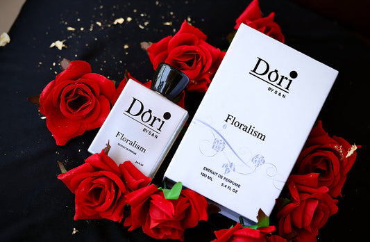 Dori Floralism Women Perfume in a sleek bottle, surrounded by red roses on a black background