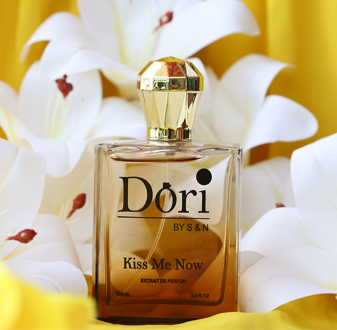 Dori BYSN Kiss Me Now women perfume in a stylish bottle surrounded by white flowers