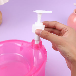 Hand installing pump on a pink double layer soap dispenser with sponge from Superior eMart