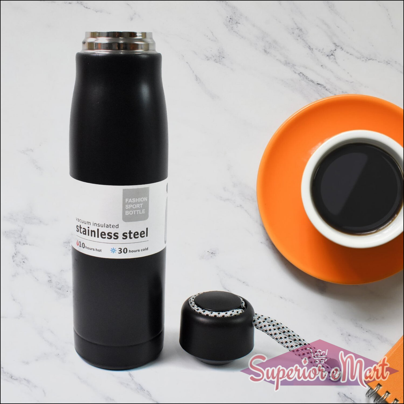 Black double wall vacuum insulated water bottle with stainless steel design and cap on a kitchen countertop