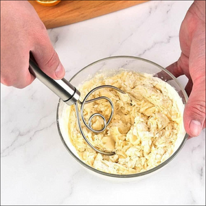 Superior eMart stainless steel dough whisk mixing batter in a glass bowl on a marble countertop